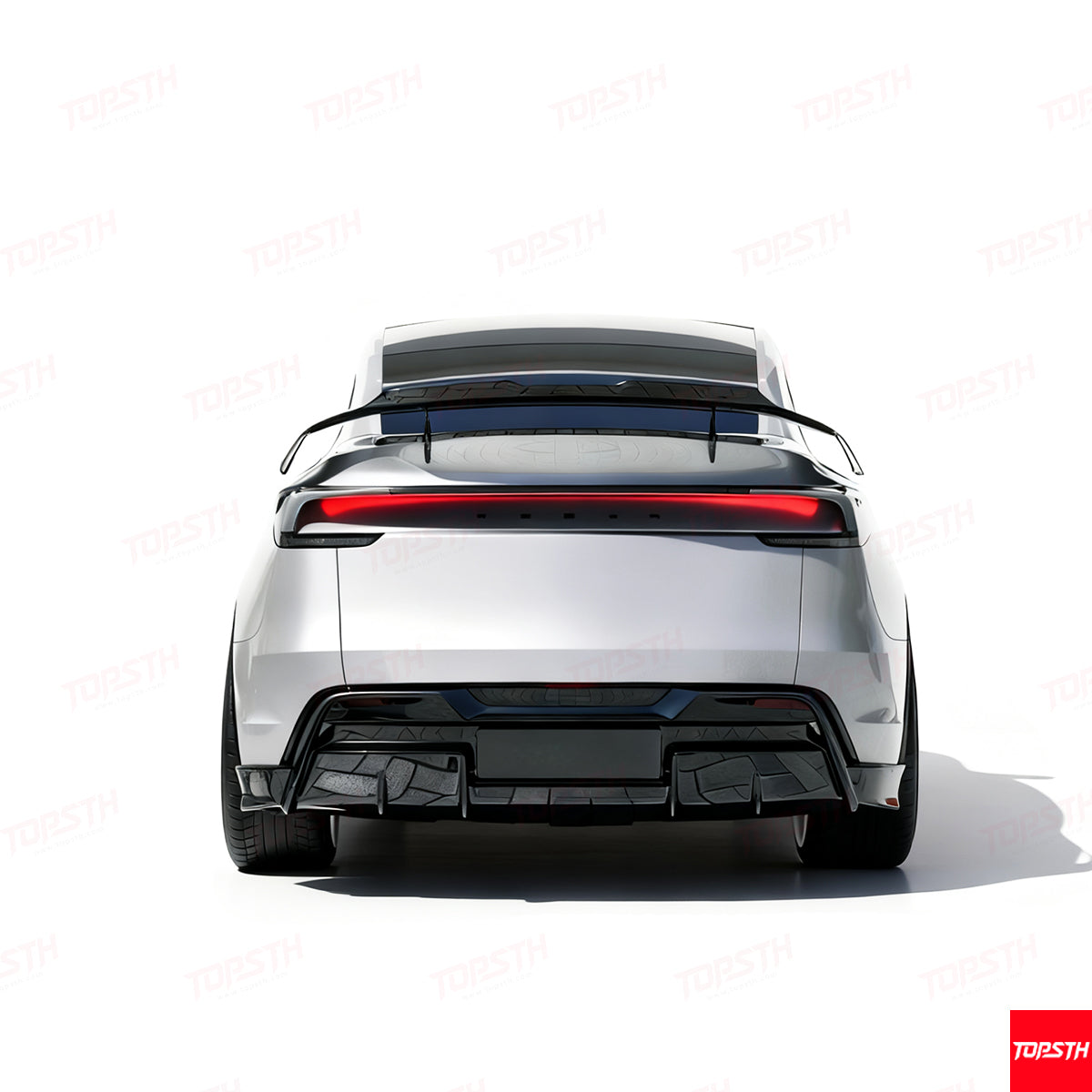 Rear view of a white Tesla Model Y showcasing a high-gloss black trunk spoiler and integrated LED light bar.