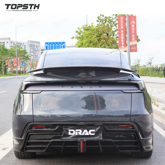 Back view of a Tesla Model Y with 'DRAC' branding on a road.
