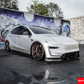 Full exterior view of a white Tesla Model Y Juniper 2025+ with the installed Carbon Fiber EL Design Body Kit.
