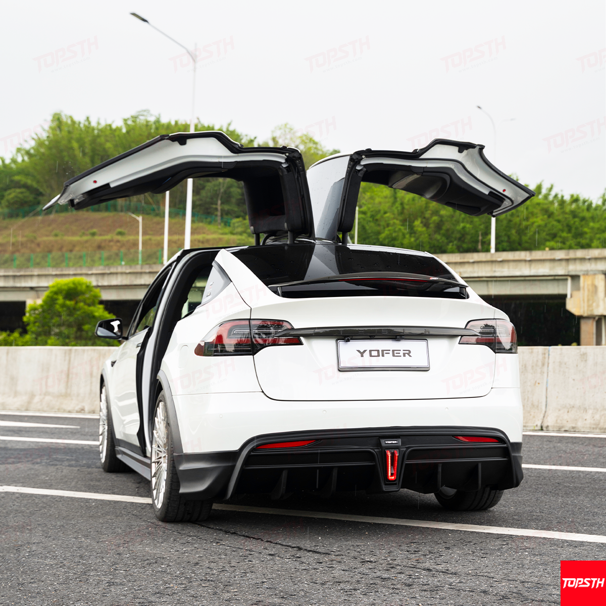 Rear three-quarter view of the Model X with YOFER Body Kit, showcasing the rear bumper and diffuser.
