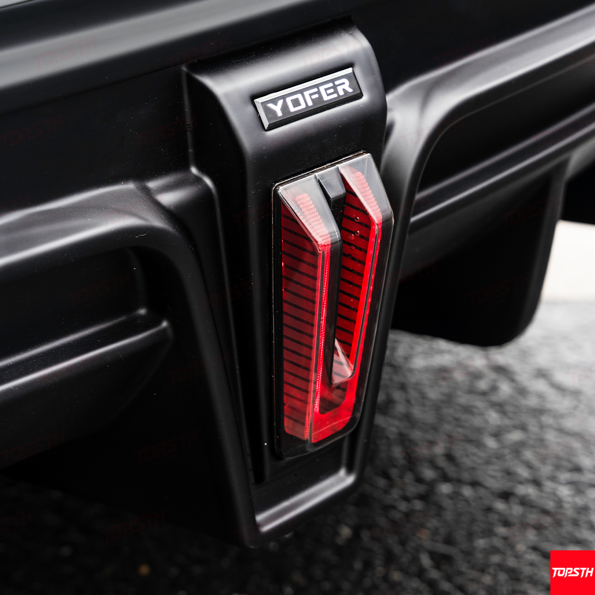 Detailed close-up of the "YOFER" branded rear light module, part of the Model X Full Body Kit.