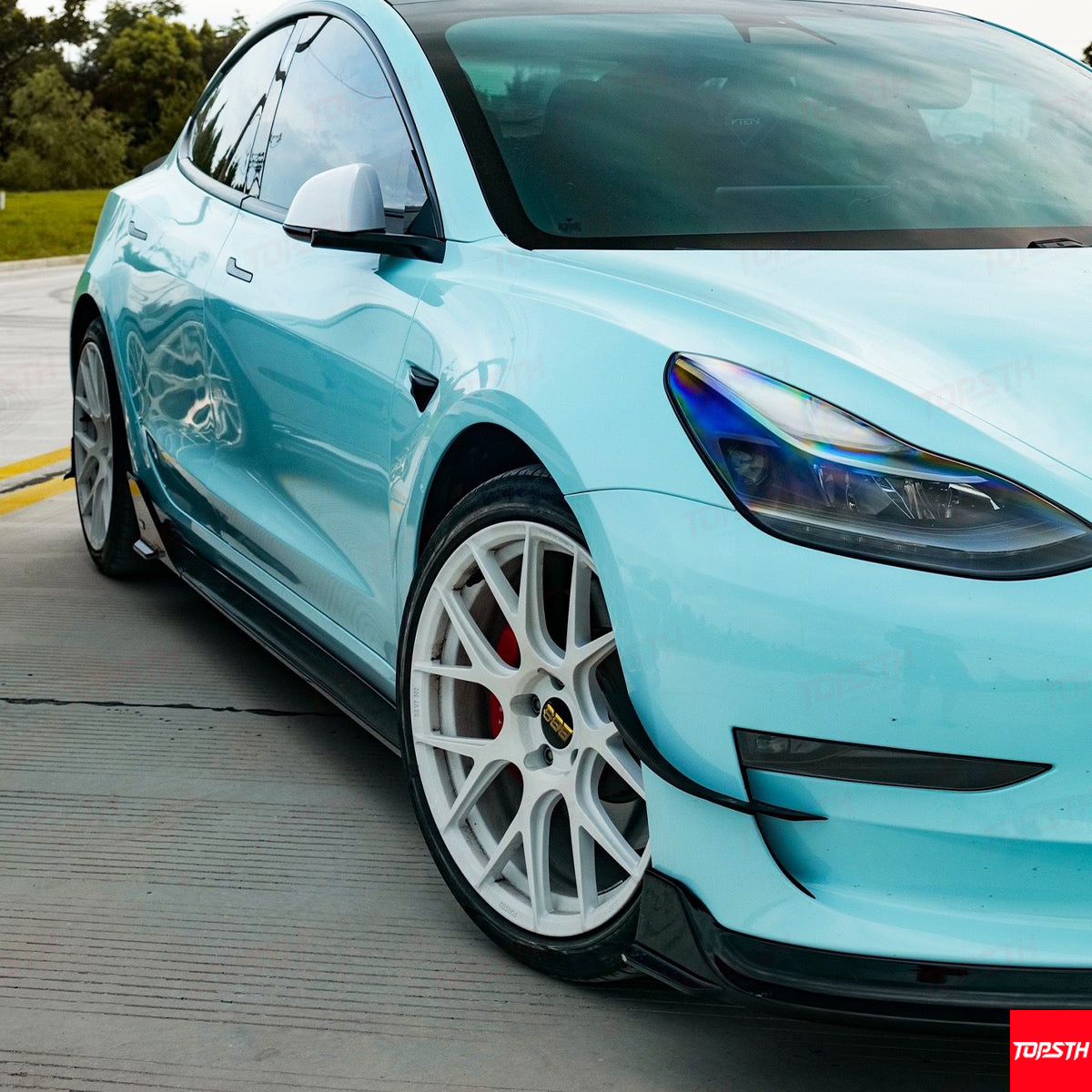 Detail view of the black side skirt extension installed on the lower rocker panel.
