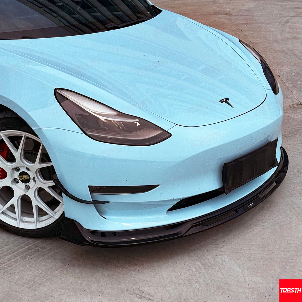 Light blue car with a visible brand logo on a wooden floor