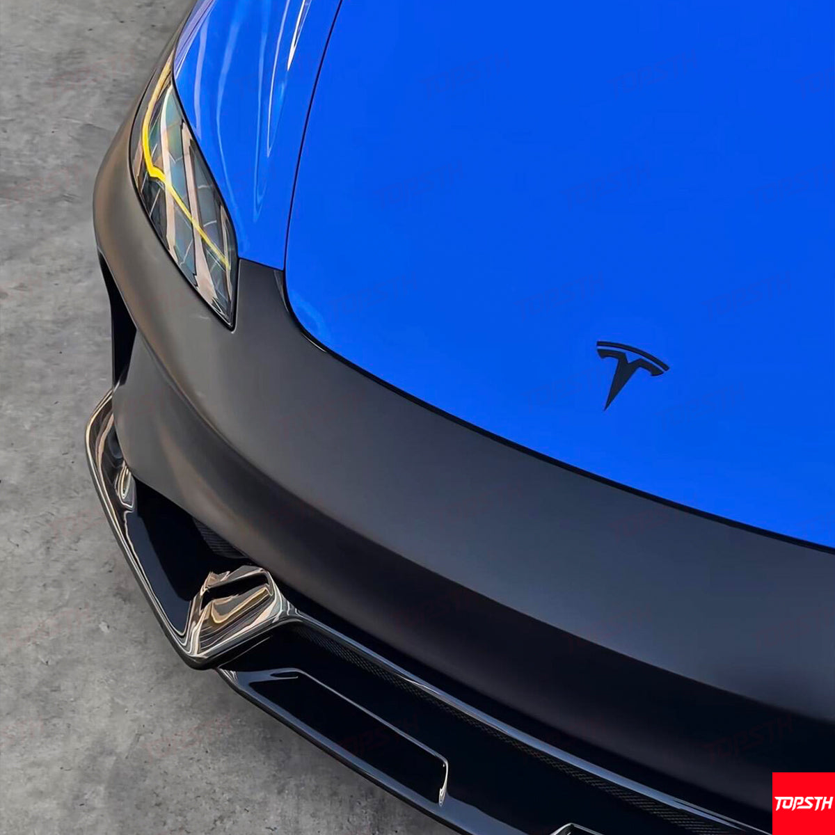 High-angle view showing the sleek lines of the ABS front bumper for Tesla Model 3 Highland.