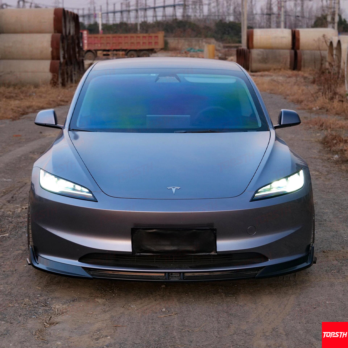 Close-up of the front bumper and lip splitter on the new Tesla Model 3 Highland model.