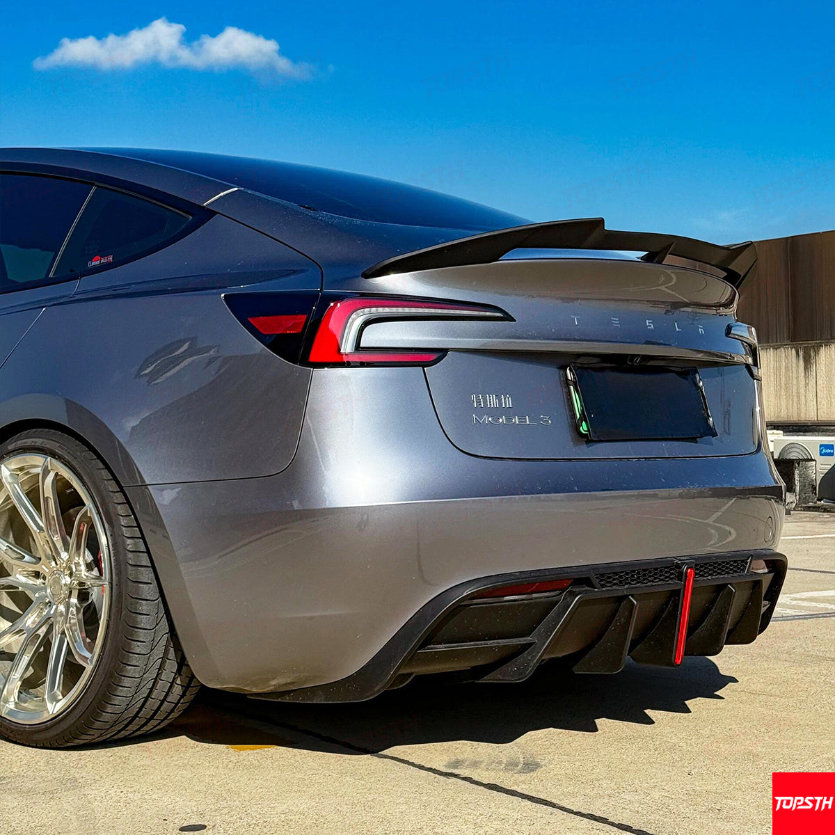Side-angle detail of the Tesla Model 3 Highland rear diffuser and performance aerodynamic kit.