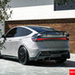 Aggressive performance-style carbon fiber wing installed on a white Tesla Model Y side profile.