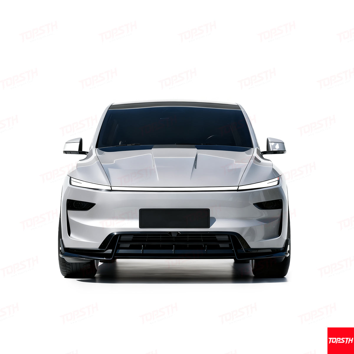 Front view of a white Tesla Model Y with a custom aggressive front bumper and lower lip spoiler.